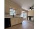 Bright kitchen with white cabinets, black appliances, and window overlooking the backyard at 4829 Woodhurst Way, Stone Mountain, GA 30088