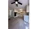 Open kitchen with white cabinets, modern appliances, and light gray floors at 4829 Woodhurst Way, Stone Mountain, GA 30088