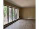 Spacious living room featuring large windows and modern floors at 4829 Woodhurst Way, Stone Mountain, GA 30088