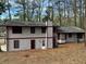 Two-story house featuring vertical siding with a private yard and mature trees at 4829 Woodhurst Way, Stone Mountain, GA 30088