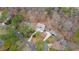 Aerial view of the property showcasing its location within a wooded neighborhood at 2590 Runic Way, Johns Creek, GA 30022