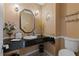 Charming powder room with granite countertop, decorative mirror, and elegant lighting fixtures at 2590 Runic Way, Johns Creek, GA 30022