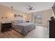 Comfortable bedroom featuring modern ceiling fan and beautiful view from bright window at 2590 Runic Way, Johns Creek, GA 30022