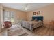 Cozy bedroom featuring a plush floral bedspread, neutral paint, and plenty of natural light at 2590 Runic Way, Johns Creek, GA 30022