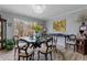 Elegant dining room features a chandelier, a large window and a round glass-topped table with seating at 2590 Runic Way, Johns Creek, GA 30022