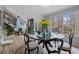 Bright dining area with glass table and chairs, with views of the lush backyard at 2590 Runic Way, Johns Creek, GA 30022