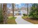 Charming home with a well-manicured front lawn and a long driveway leading to the entrance at 2590 Runic Way, Johns Creek, GA 30022