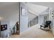 Hallway with carpet, modern railing, and a view of the living room at 2590 Runic Way, Johns Creek, GA 30022