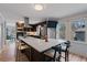 Bright kitchen featuring an island with a white countertop, stainless steel appliances, and dark wood cabinets at 2590 Runic Way, Johns Creek, GA 30022