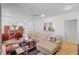 Spacious living room with a cozy couch, colorful rug, and adjacent dining area at 2590 Runic Way, Johns Creek, GA 30022