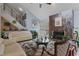 Comfortable living room featuring a fireplace, plush seating, and views to the backyard at 2590 Runic Way, Johns Creek, GA 30022