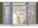 Balcony view through French doors showcasing a garden and neighborhood scenery at 1231 Wildcliff Cir, Atlanta, GA 30329