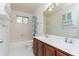 This bathroom features double sinks, a combination tub/shower, tile floors, and an abundance of cabinet space at 1231 Wildcliff Cir, Atlanta, GA 30329