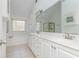 This bathroom features dual sinks, a large mirror, a separate shower, and a garden tub with a window view at 1231 Wildcliff Cir, Atlanta, GA 30329