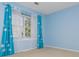 Bright bedroom with light blue walls, neutral carpet, one window with blinds, and attractive cloud patterned curtains at 1231 Wildcliff Cir, Atlanta, GA 30329