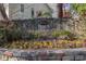Stone monument sign for Wildcliff community with flower bed and green foliage at 1231 Wildcliff Cir, Atlanta, GA 30329