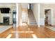 Inviting home foyer featuring hardwood floors, staircase, and a glimpse of the fireplace and kitchen at 1231 Wildcliff Cir, Atlanta, GA 30329