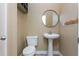 Cozy half bathroom features a pedestal sink, a round mirror, and neutral wall paint at 1231 Wildcliff Cir, Atlanta, GA 30329