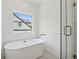 Relaxing bathroom featuring a standalone tub, a window, and a glass-enclosed shower at 240 Mount Zion Rd, Hapeville, GA 30354