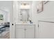 Chic half bathroom featuring modern fixtures, white cabinetry, and stylish decor at 240 Mount Zion Rd, Hapeville, GA 30354