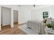 Bright bedroom with hardwood floors, light walls, a ceiling fan, and large windows at 240 Mount Zion Rd, Hapeville, GA 30354