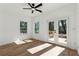 Bright room with hardwood floors, a ceiling fan, french doors to a wooden deck, and plenty of natural light at 240 Mount Zion Rd, Hapeville, GA 30354