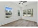 Bright room with hardwood floors, three windows overlooking the neighborhood, and ample natural light at 240 Mount Zion Rd, Hapeville, GA 30354