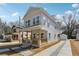 Charming two-story home featuring a cozy front porch and a long driveway leading to a detached garage at 240 Mount Zion Rd, Hapeville, GA 30354