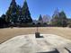 Large backyard featuring a circular patio with a metal fire pit and chairs at 3817 Bay Orchard Ln, Loganville, GA 30052