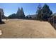 Large fenced backyard with mature trees at property's edge at 3817 Bay Orchard Ln, Loganville, GA 30052