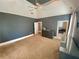 This bedroom features neutral walls, a ceiling fan, and a light-colored carpet. It's bright and airy at 3817 Bay Orchard Ln, Loganville, GA 30052