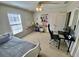 Bedroom features a daybed, office space, shelving, and a ceiling fan at 3817 Bay Orchard Ln, Loganville, GA 30052