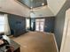 Spacious carpeted bedroom features vaulted ceilings, ceiling fan, neutral walls, and French doors to outdoor space at 3817 Bay Orchard Ln, Loganville, GA 30052