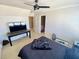 Bedroom with large ceiling fan, big window and modern tv stand at 3817 Bay Orchard Ln, Loganville, GA 30052