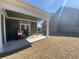 Covered patio with seating and a view of the spacious backyard with mature trees at 3817 Bay Orchard Ln, Loganville, GA 30052