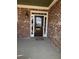 View of a beautiful brick home featuring a front door with sidelights and transom windows at 3817 Bay Orchard Ln, Loganville, GA 30052