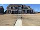 Charming two-story home with a mix of brick and siding, complemented by a well-manicured lawn at 3817 Bay Orchard Ln, Loganville, GA 30052