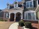 Charming two-story home with a mix of brick and siding, complemented by a well-manicured lawn at 3817 Bay Orchard Ln, Loganville, GA 30052