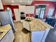 Modern kitchen with an island, granite countertops, and stainless steel appliances at 3817 Bay Orchard Ln, Loganville, GA 30052