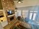 Cozy living room with a brick fireplace, built-in shelving, and lots of natural light at 3817 Bay Orchard Ln, Loganville, GA 30052