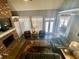 Spacious living room featuring a brick fireplace, hardwood floors, and a large window for natural light at 3817 Bay Orchard Ln, Loganville, GA 30052