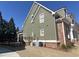 Side view of home showing neutral siding, brick accents and manicured lawn at 3817 Bay Orchard Ln, Loganville, GA 30052