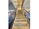 Carpeted staircase with wood railing and ornate black iron spindles at 3817 Bay Orchard Ln, Loganville, GA 30052