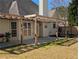 Backyard with a covered patio, grassy area, landscaping and a wooden fence at 510 Pittman Mill Ct, Loganville, GA 30052