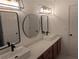 Bathroom featuring dual sinks, modern fixtures, and cabinet space at 510 Pittman Mill Ct, Loganville, GA 30052