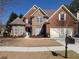 Charming two-story brick home with stone accents, manicured lawn, and an attached two-car garage at 510 Pittman Mill Ct, Loganville, GA 30052