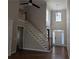 Bright foyer featuring a staircase, high ceilings, hardwood floors, and large windows at 510 Pittman Mill Ct, Loganville, GA 30052