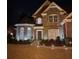 Well-lit front exterior of a brick home at night, showcasing the entryway and landscaping at 510 Pittman Mill Ct, Loganville, GA 30052