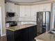 Modern kitchen with white cabinets, granite countertops, stainless steel appliances, and a central island at 510 Pittman Mill Ct, Loganville, GA 30052