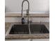 Close-up of a stainless steel kitchen sink with modern faucet and granite countertop at 510 Pittman Mill Ct, Loganville, GA 30052